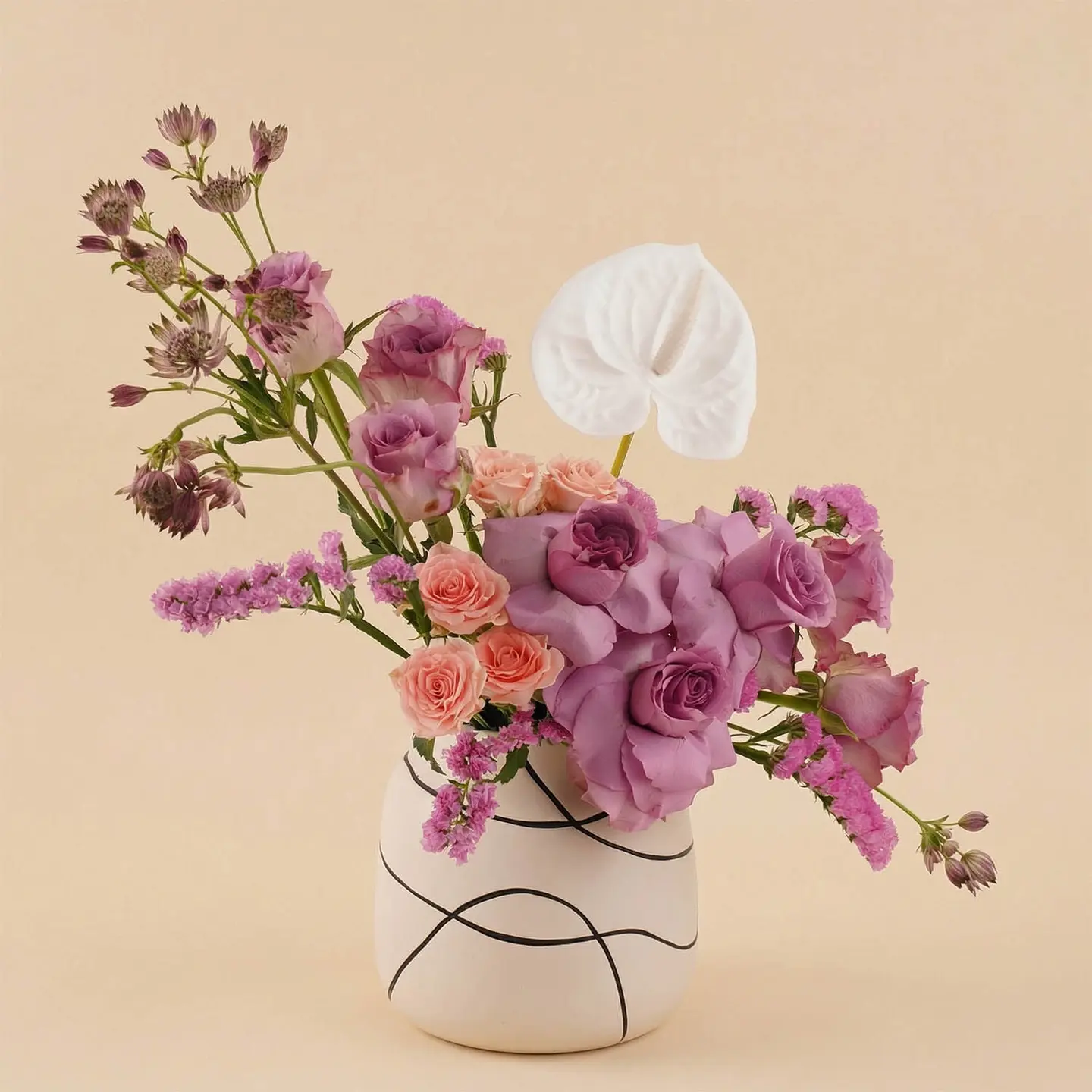 A Vase Of Purple Roses With White Anthuriums