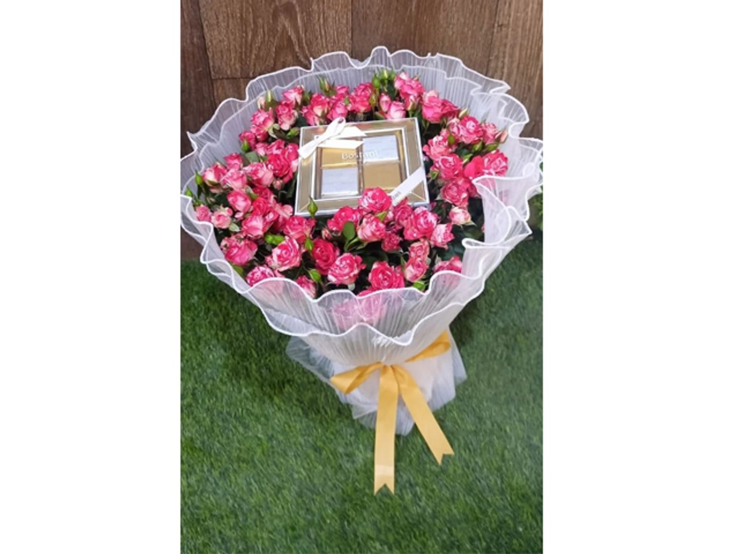 A Quarter Kilo Of Patchi Chocolate With Yellow And White Flowers