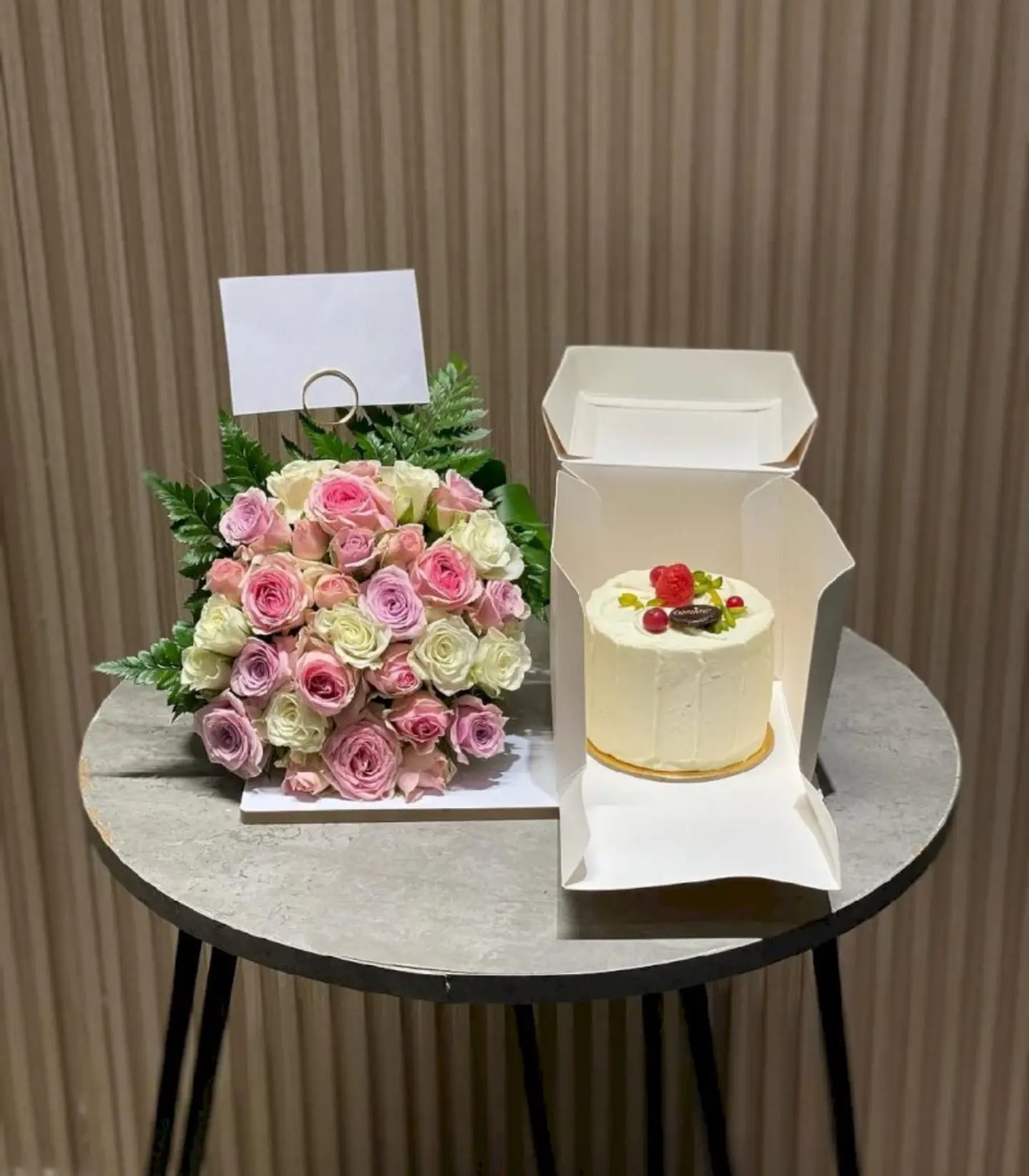 A Kandera Red Velvet Cake With Roses On A Wooden Board
