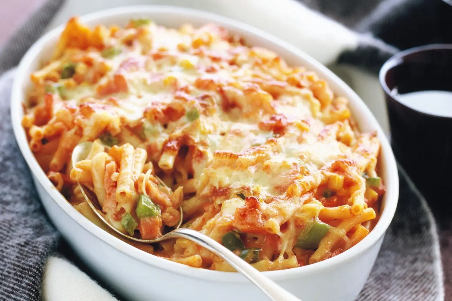 A Tray Of Red Pasta With Cheese