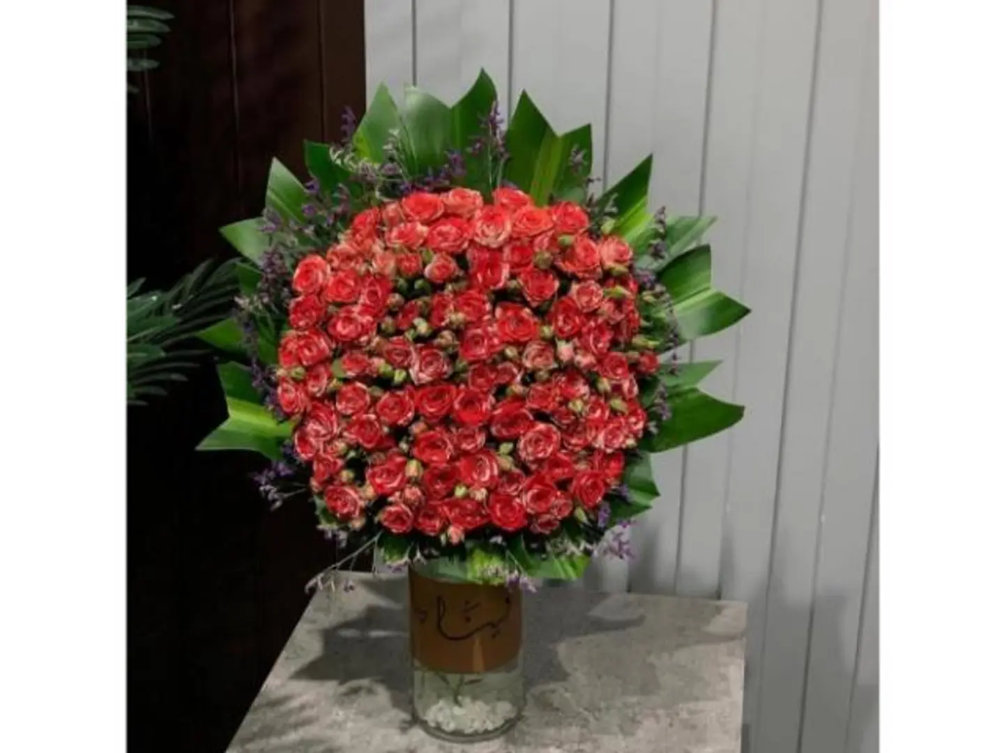 The Red Grove Of Adoration In A Tall Glass Vase