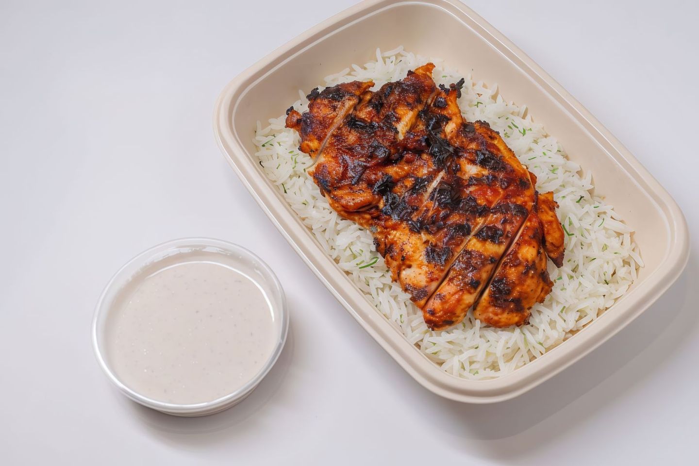 Half A Pulled Chicken Grilled On Charcoal With Rice
