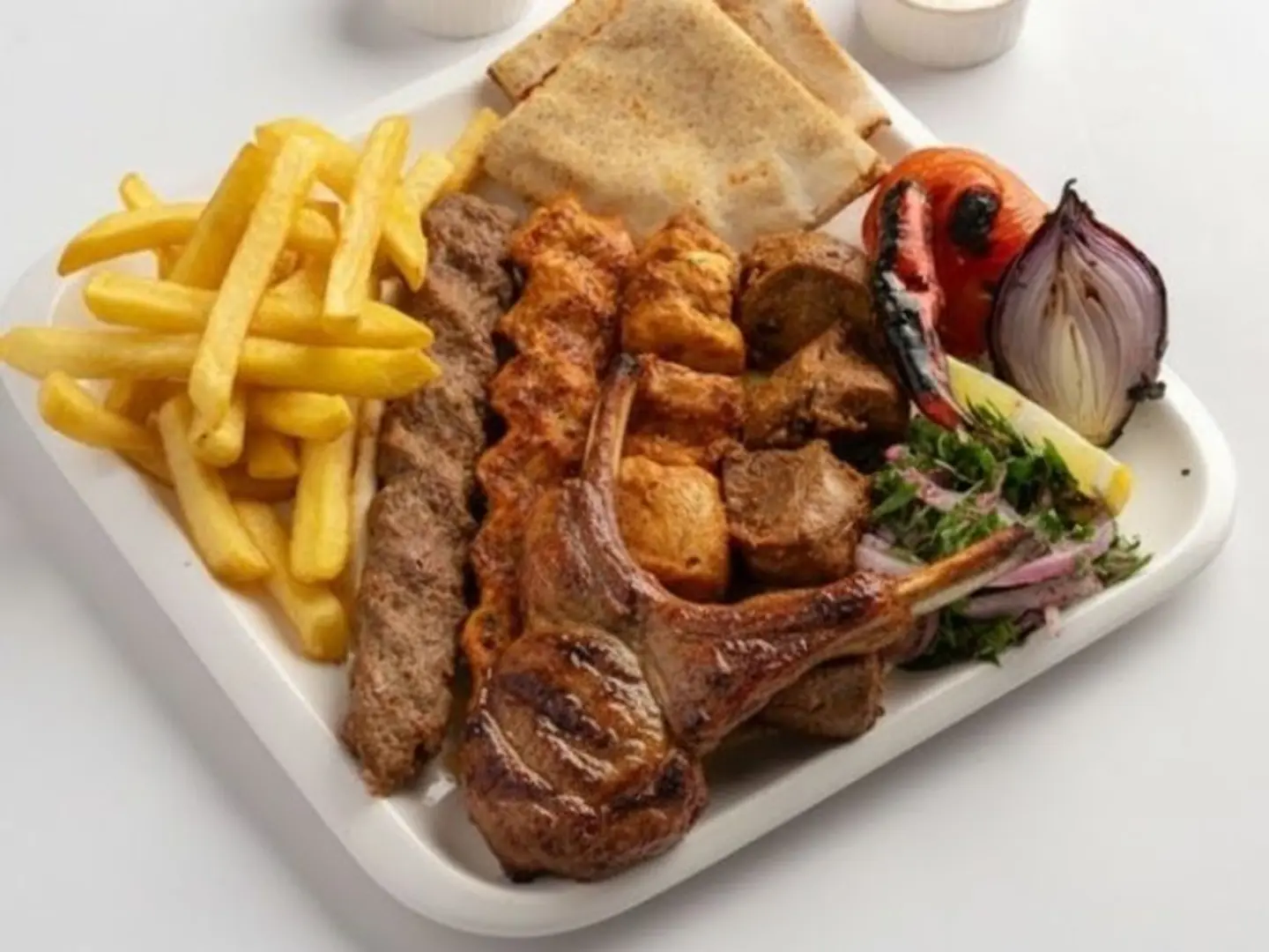 Four Skewers Of Fresh Grilled Meat And Chicken With A Rib