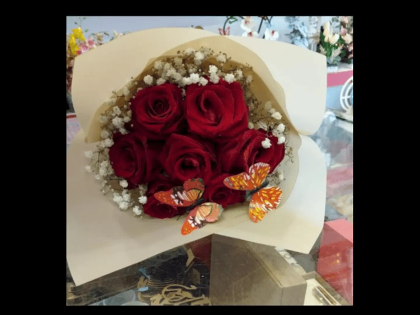 A Bouquet Of Seven Roses And A Butterfly