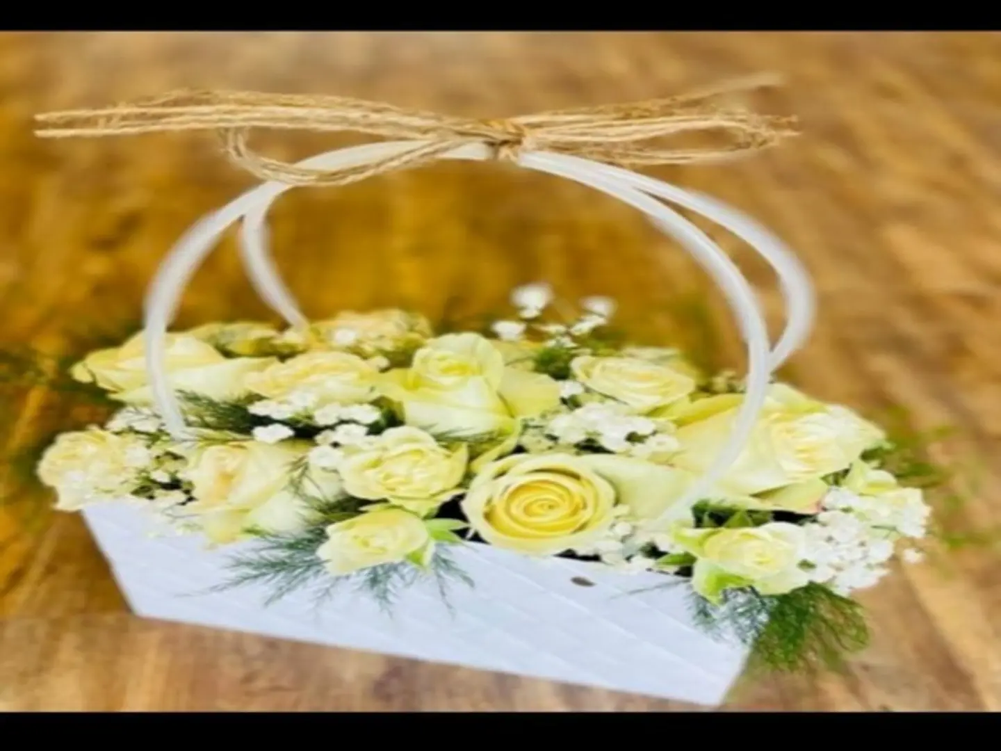 A Rectangular Rose Basket With White Roses