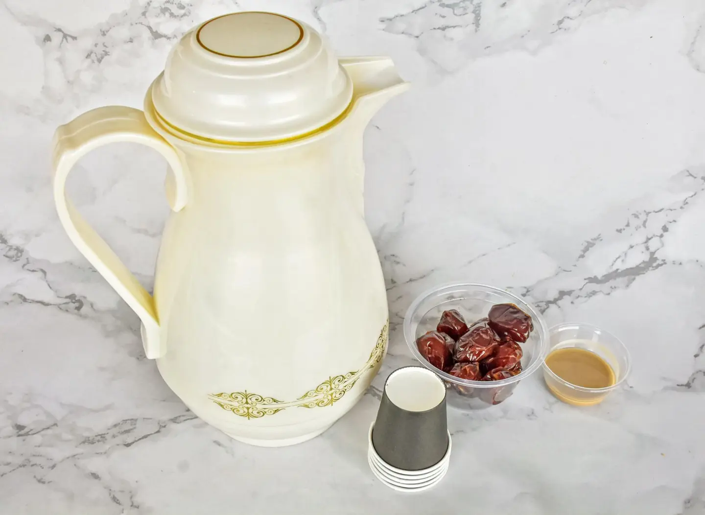A Thermos Of Saudi Masmar Coffee With Fine Dates And Tahini