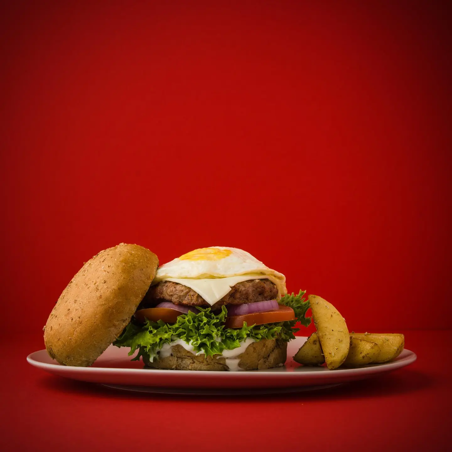 Beef Burger With Eggs And Potato Wedges