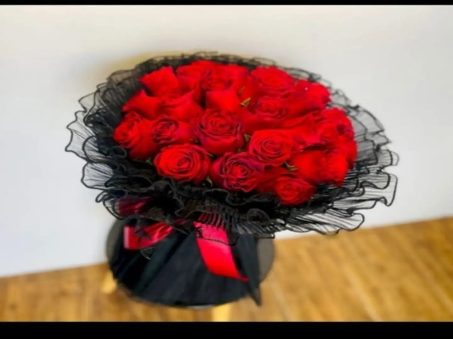 A Bouquet Of Red Roses With Black Lace Wrapping
