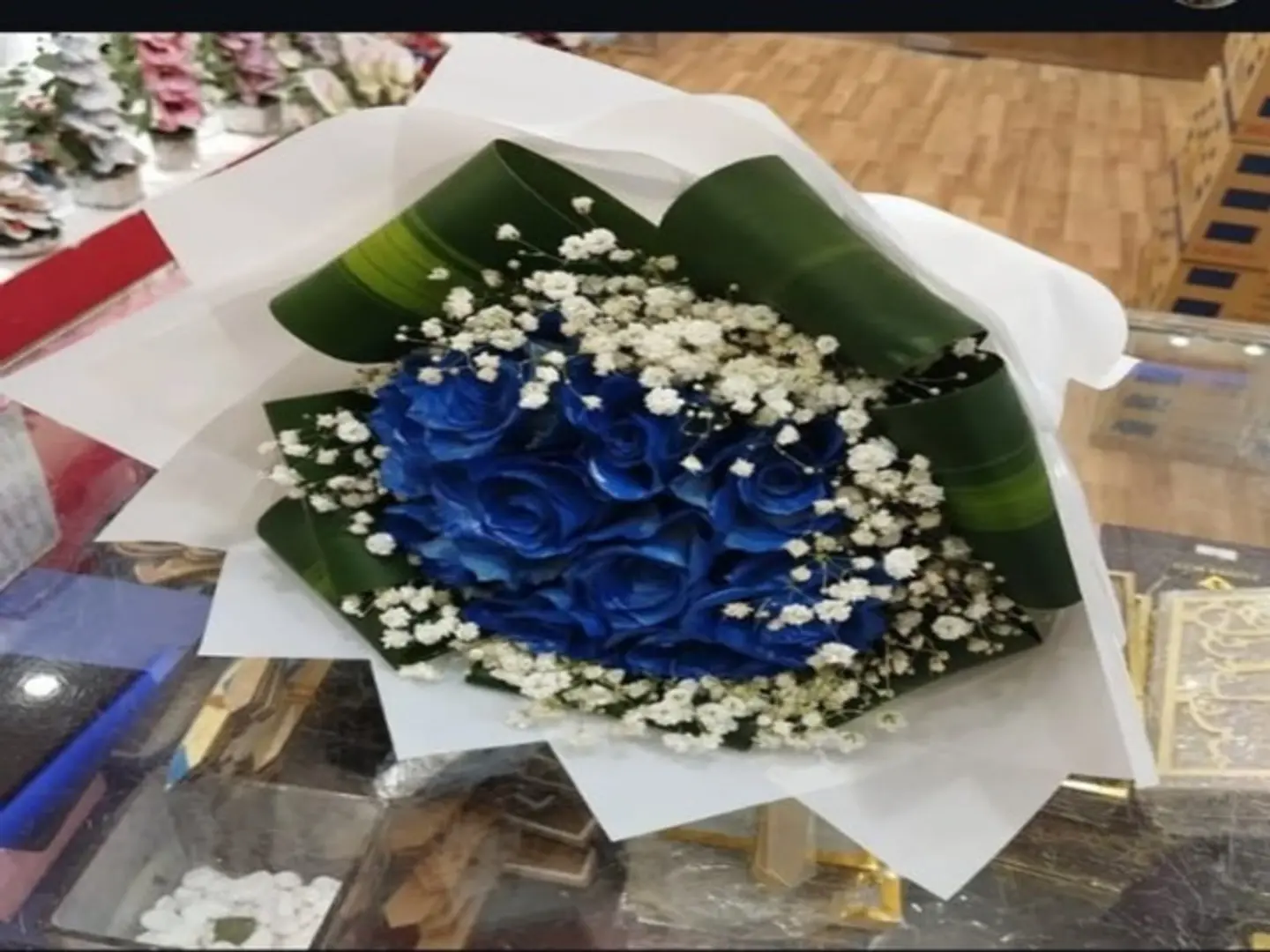 A Bouquet Of Blue Roses With Dracaena Branches
