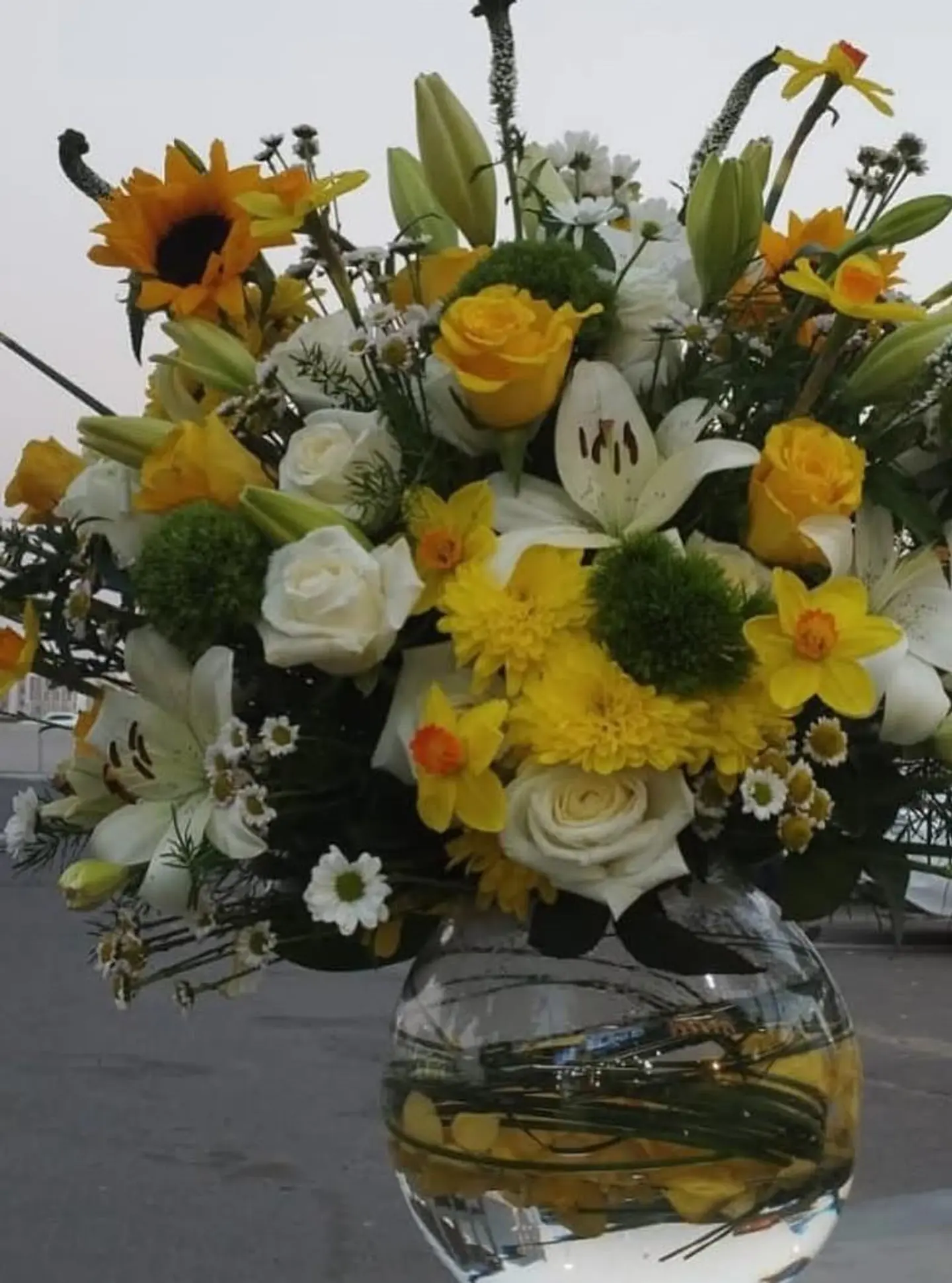 Transparent Vase With White And Yellow Flowers