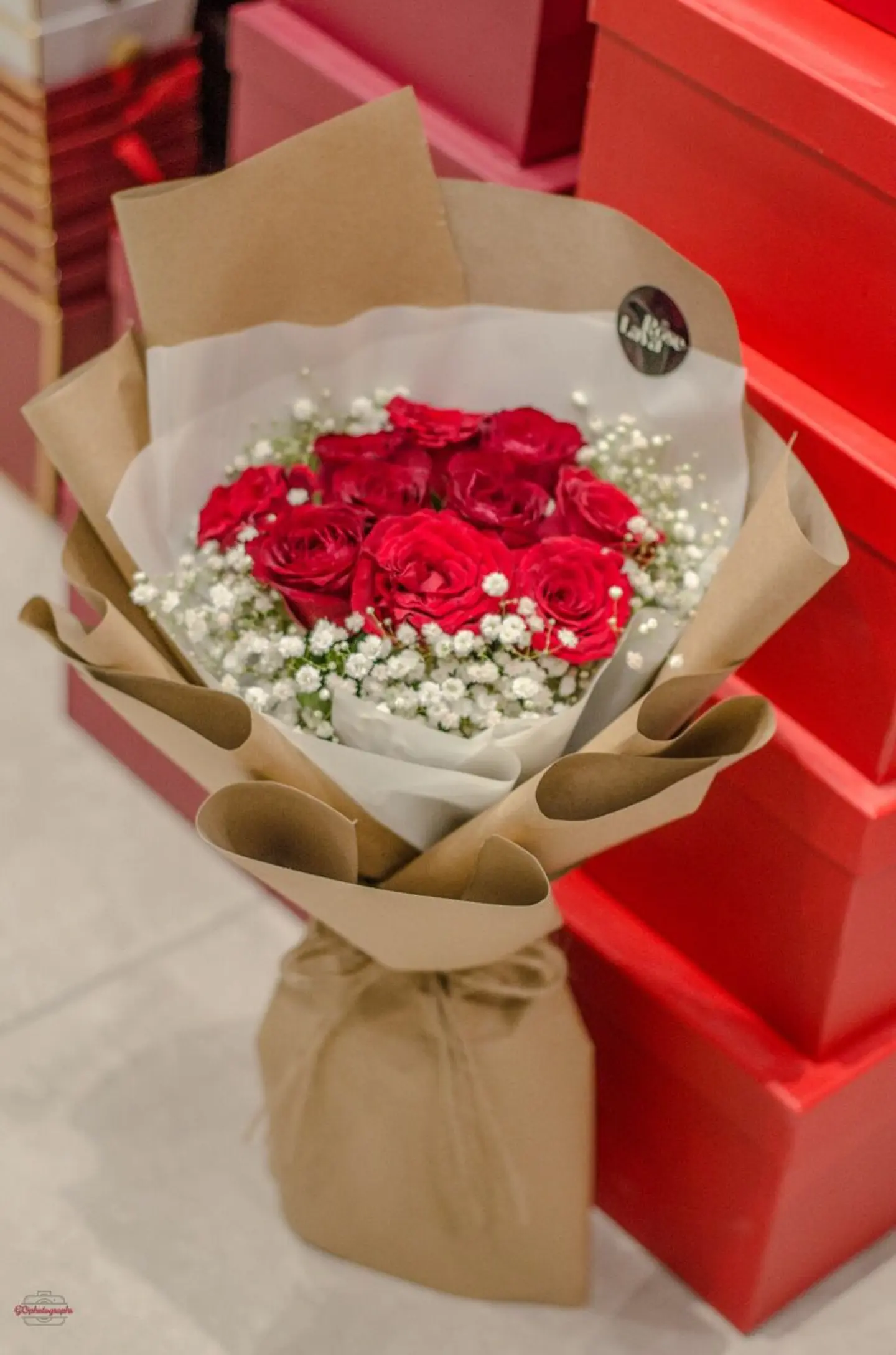 Red Bouquet In Brown Paper