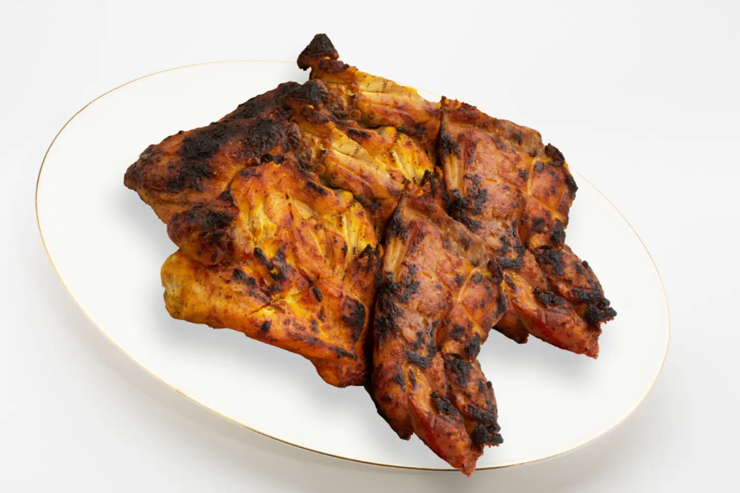 A Whole Chicken Grilled On Coal