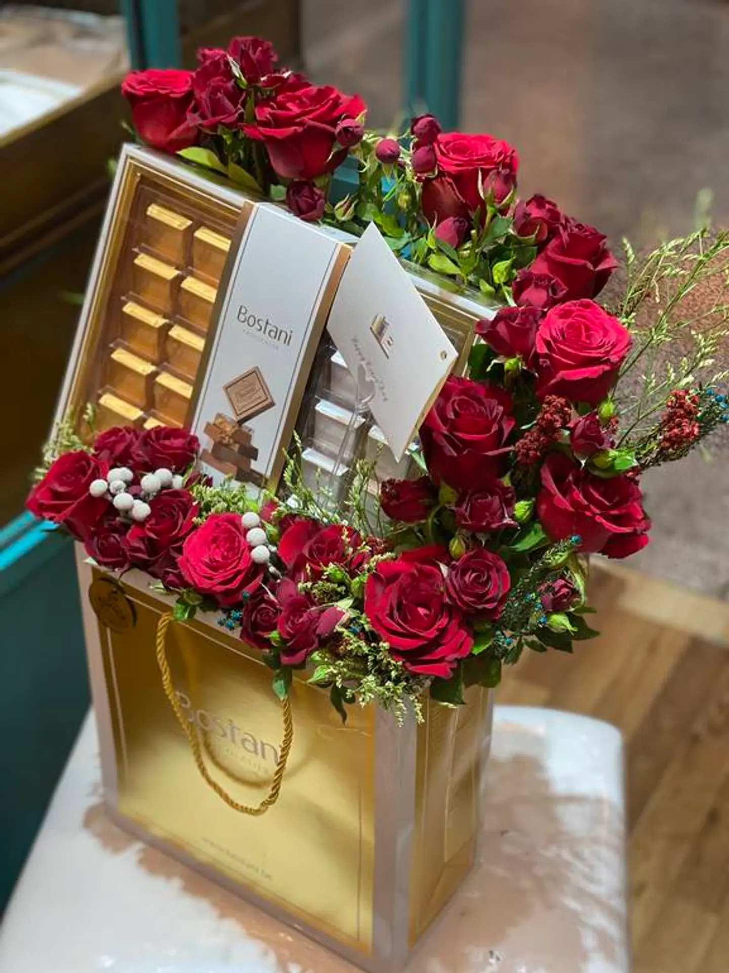 Bag Of Bostani Chooclate With Red And White Flowers