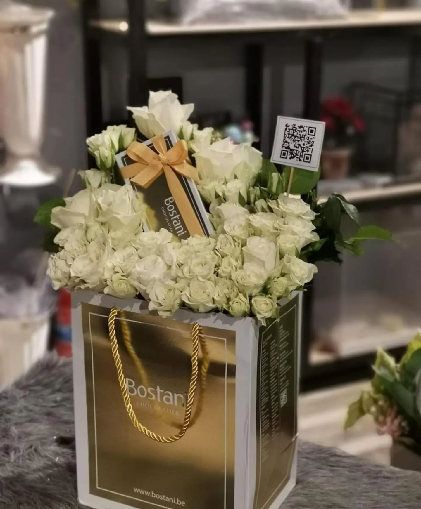 Bag Of Patchi Chooclate With White Flowers