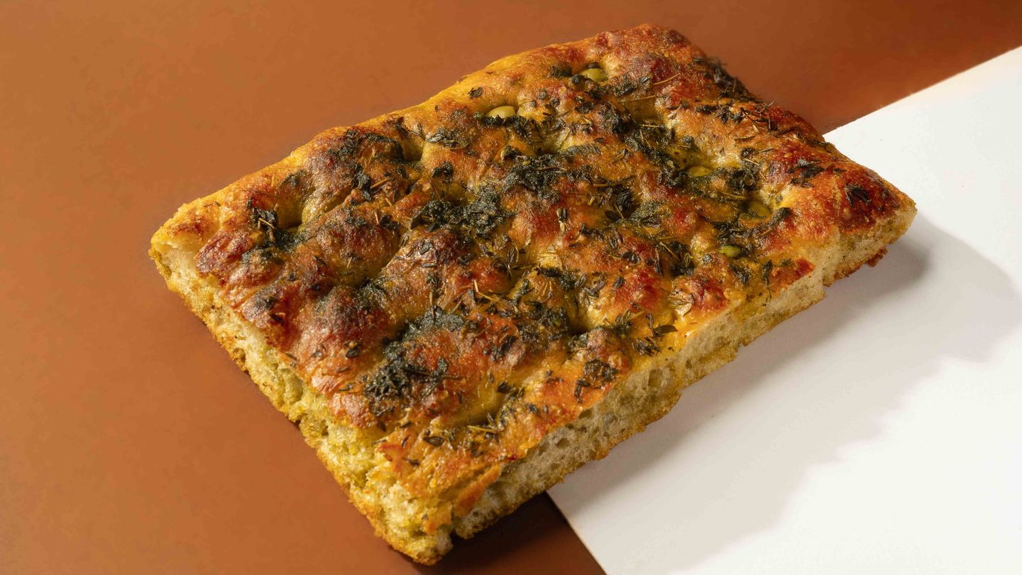 Focaccia With A Mix Of Green Olives Basil Pesto And Herbs