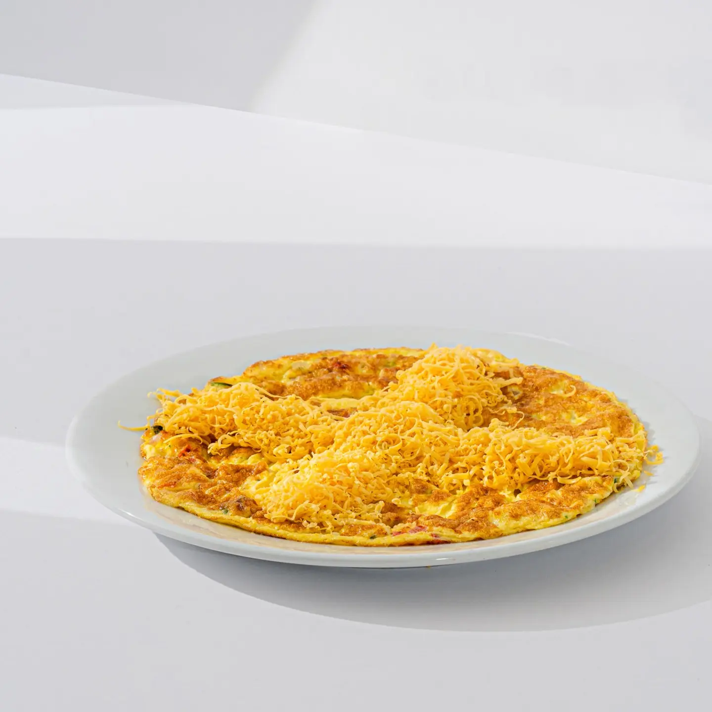 Baked Eggs With Tomatoes Onions And Cheddar Cheese