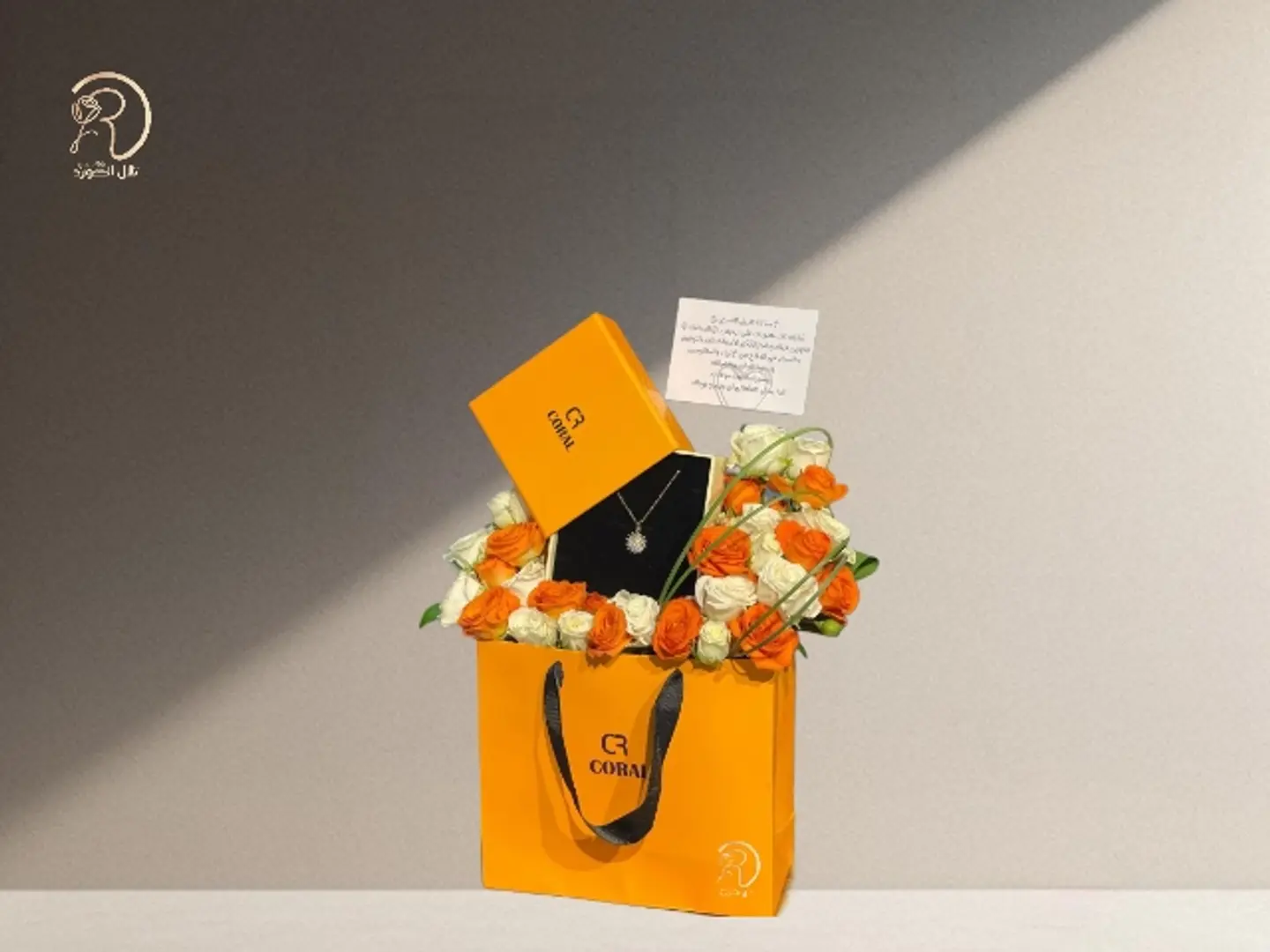 Elegant Arrangement With Modern Roses And A Contemporary Coral Chain