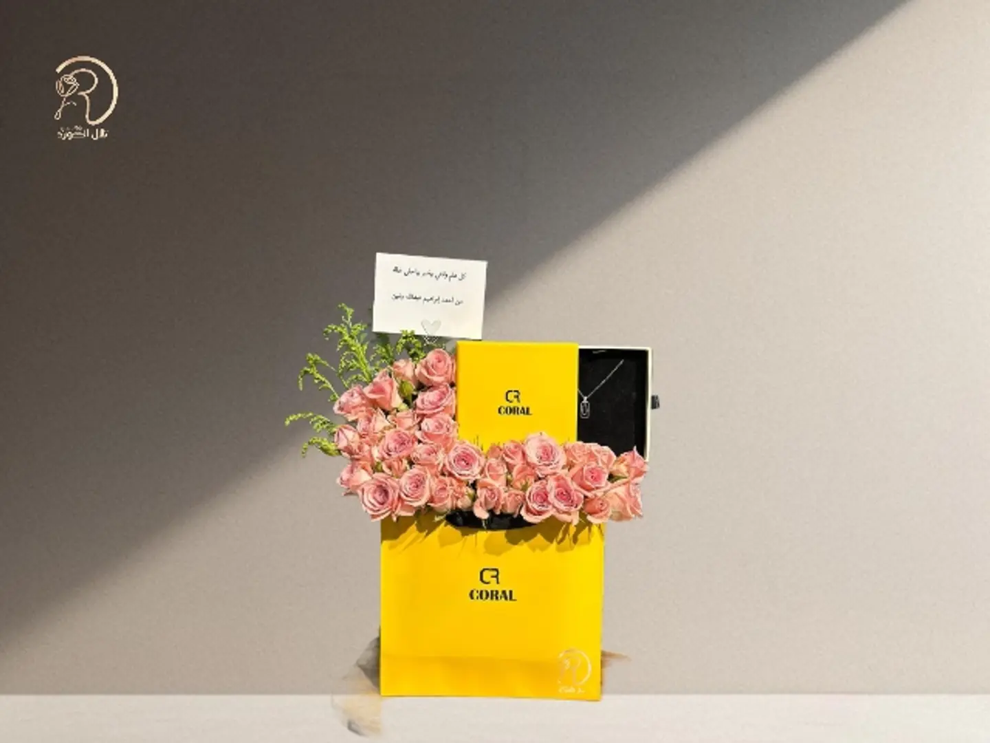 An Arrangement Of Aura Of Beauty Roses And A Necklace