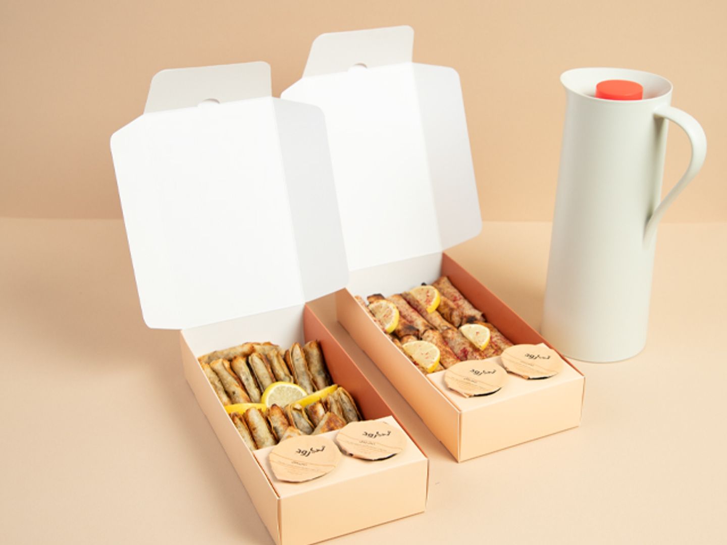 A Box Of Samosas And Musakhan With A Liter Of Drink.