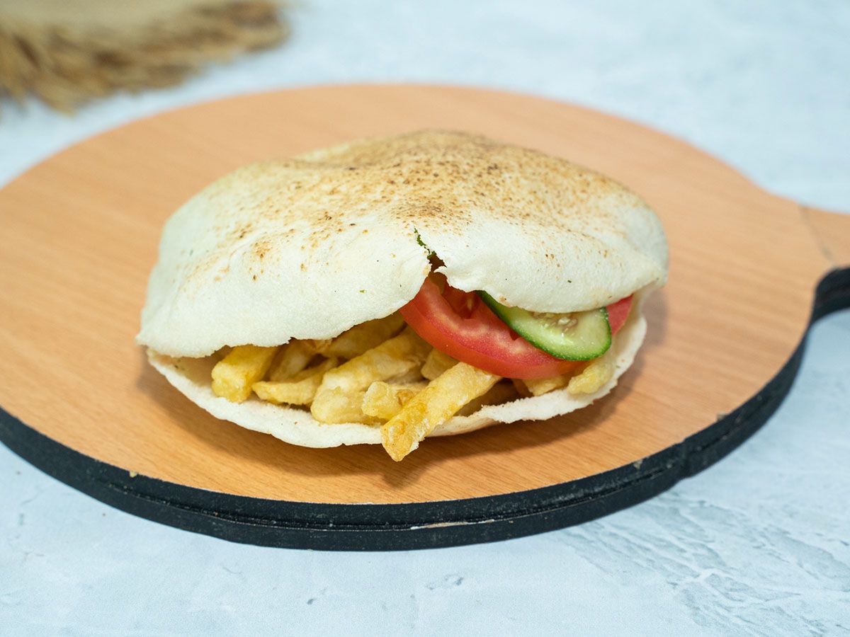 French fries sandwich with salad and tahini