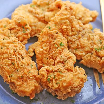 Small crispy boneless meal with rice and potatoes