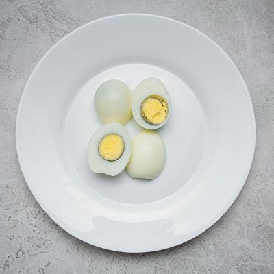 Dish of 2 boiled eggs with tahini