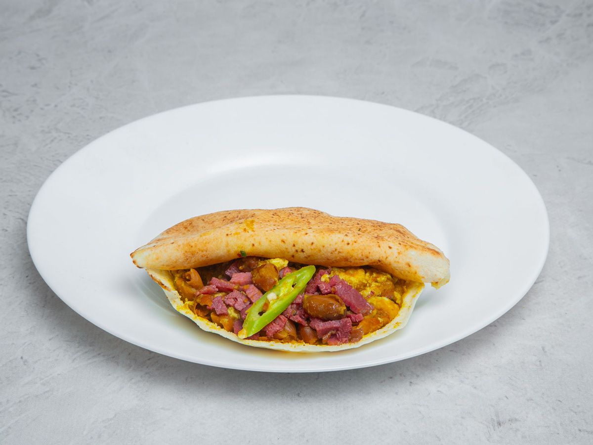 Foul With Pastrami And Eggs Sandwich