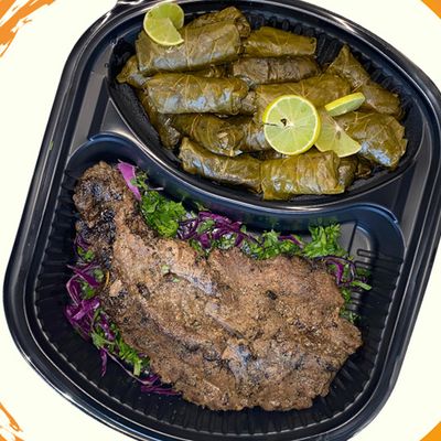 Beef steak meal with grape leaves