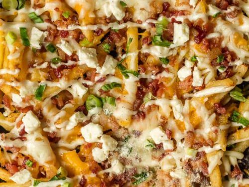 French Fries With Chicken Pieces And Cheddar Cheese Sauce And Jalapeno Sauce