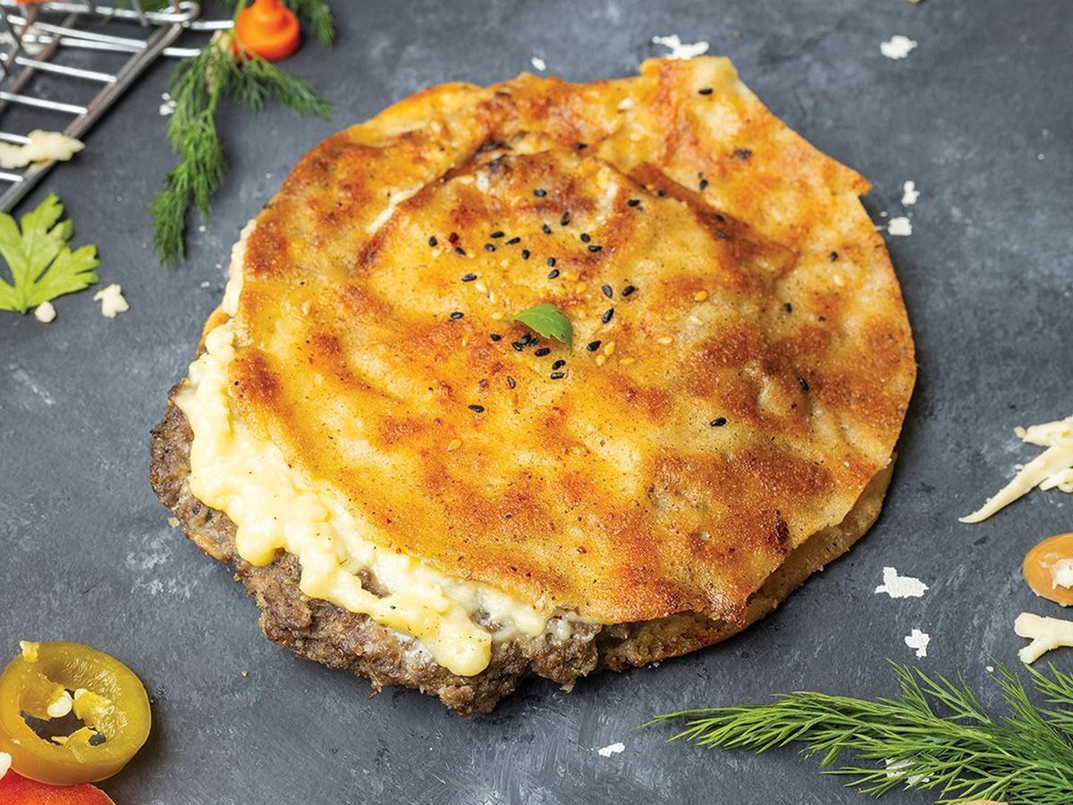 Hawawshi loaf sandwich with cheese and olives