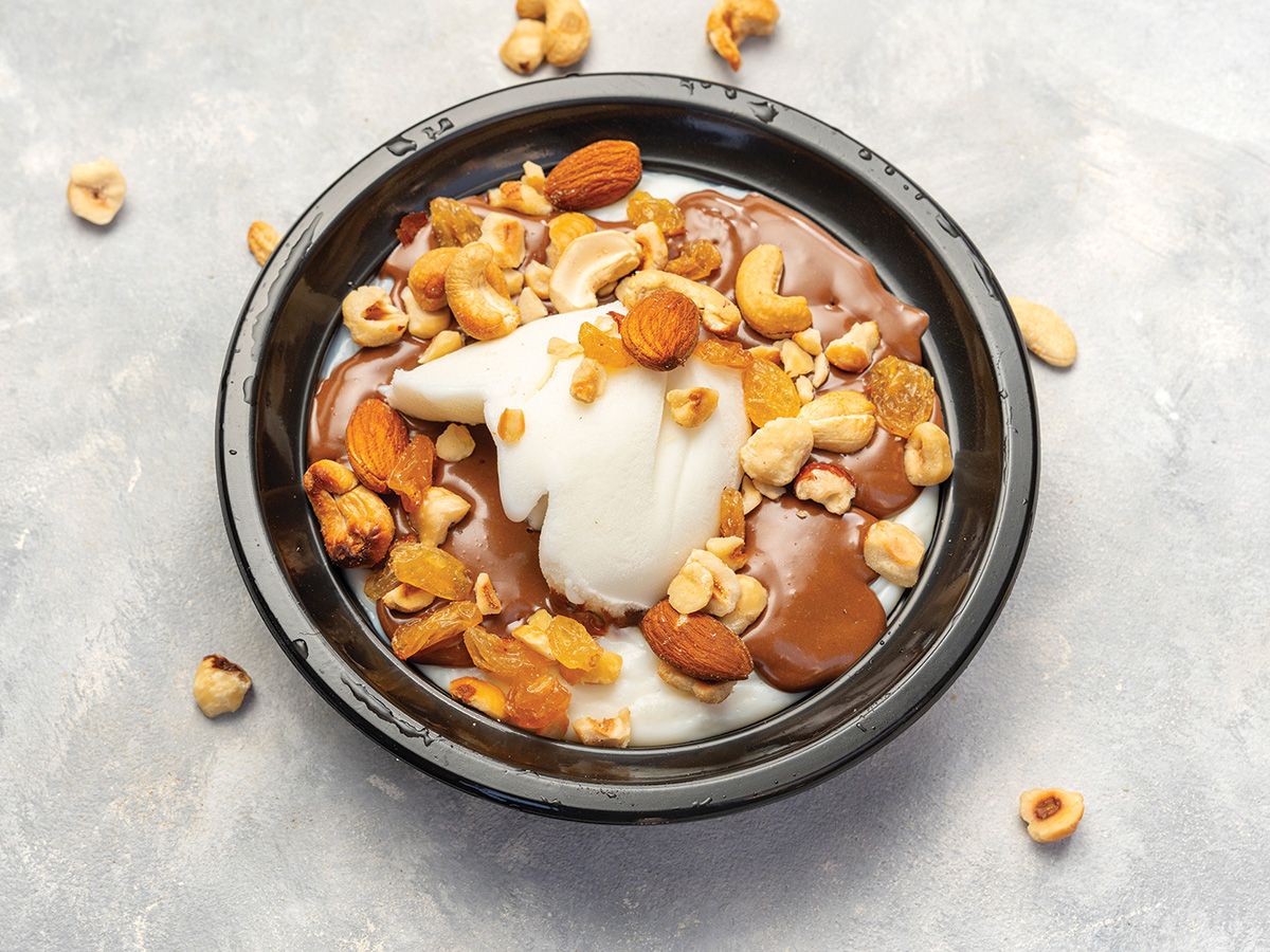 Rice pudding with ice cream, nuts, and sauce