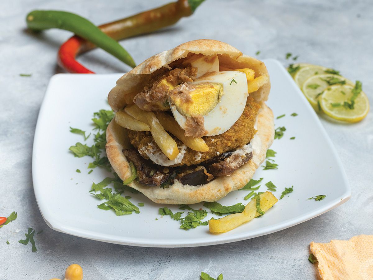 Foul medames with falafel, eggplant, potatoes, and eggs