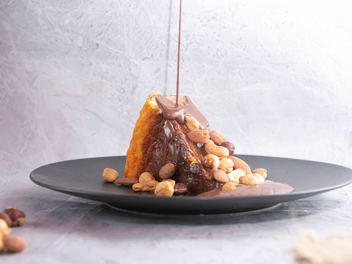 San Sebastian Cheese Cake Topped With Nutella And Nuts