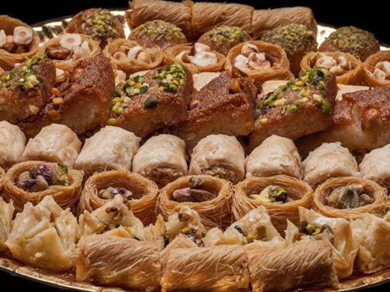 A Plate Of Mixed Sweets With All With Nuts and Honey