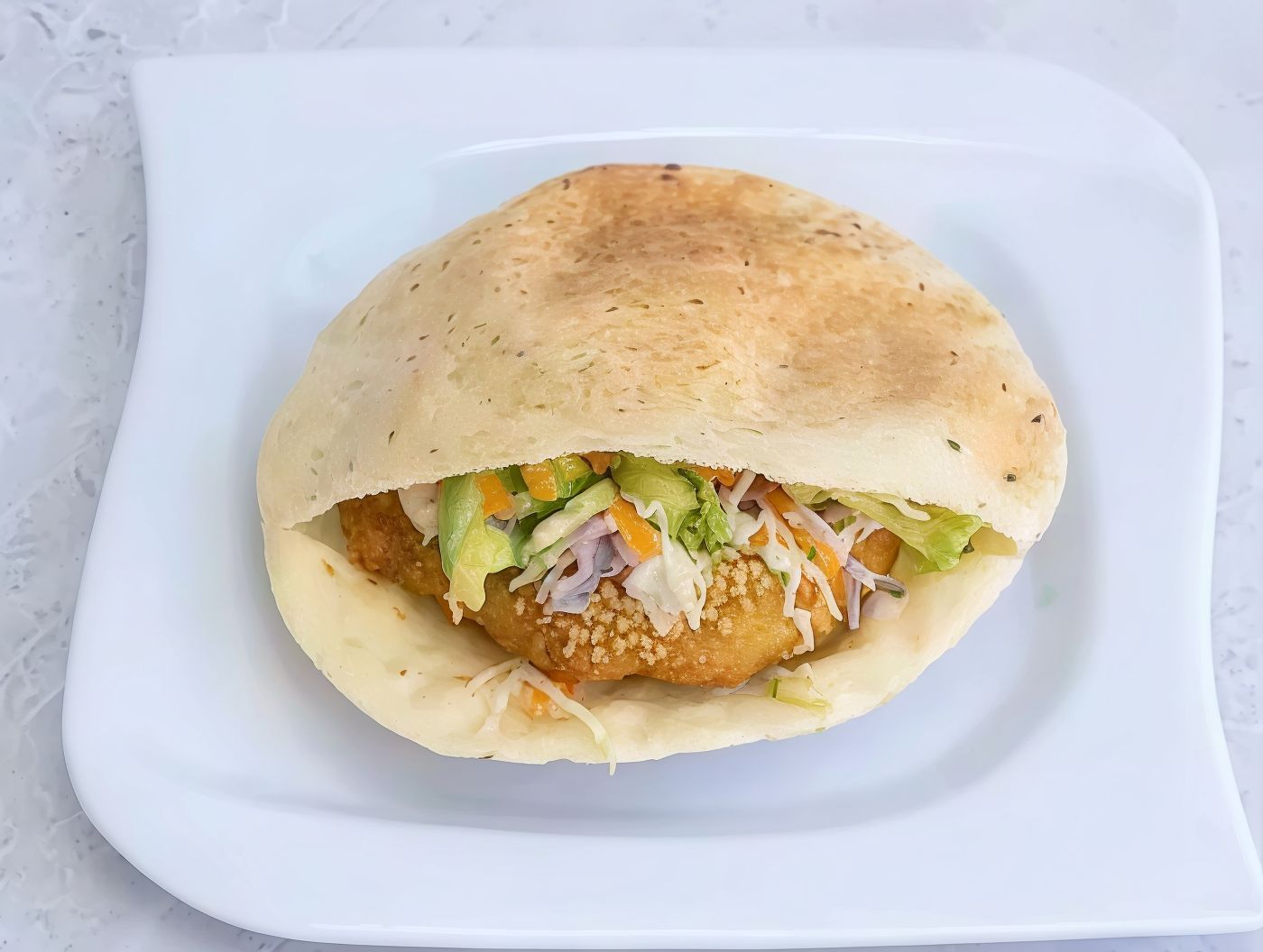 Falafel sandwich stuffed with green salad