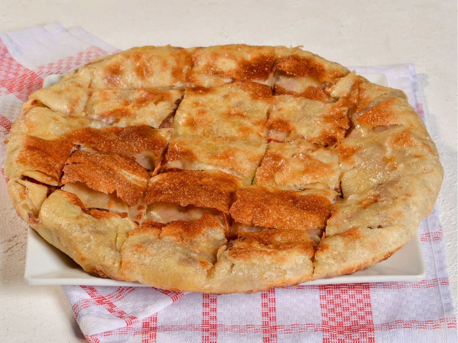 Savory pie with hot dog and basturma