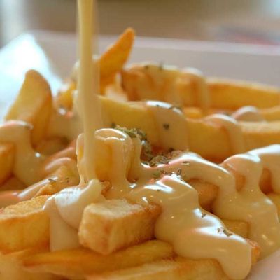 Packet of finger fries with cheddar sauce