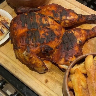 Charcoal grilled chicken served with rice and potatoes for two people