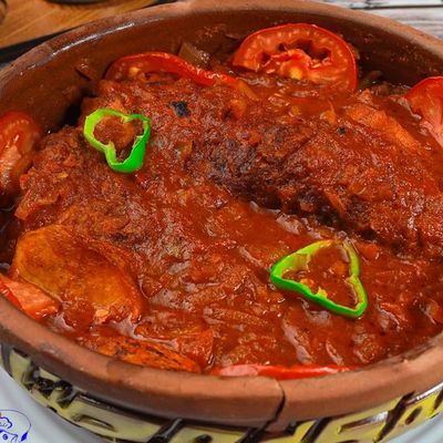 Mullet fish tagine with potatoes and red sauce