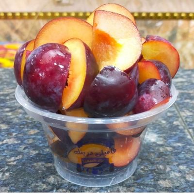 A Box Of Cut Plums