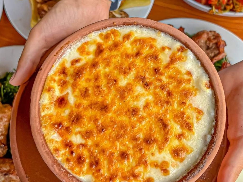Béchamel pasta casserole with meat in earthenware