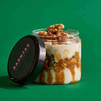 Yogurt with dates, granola, caramel sauce, and walnuts