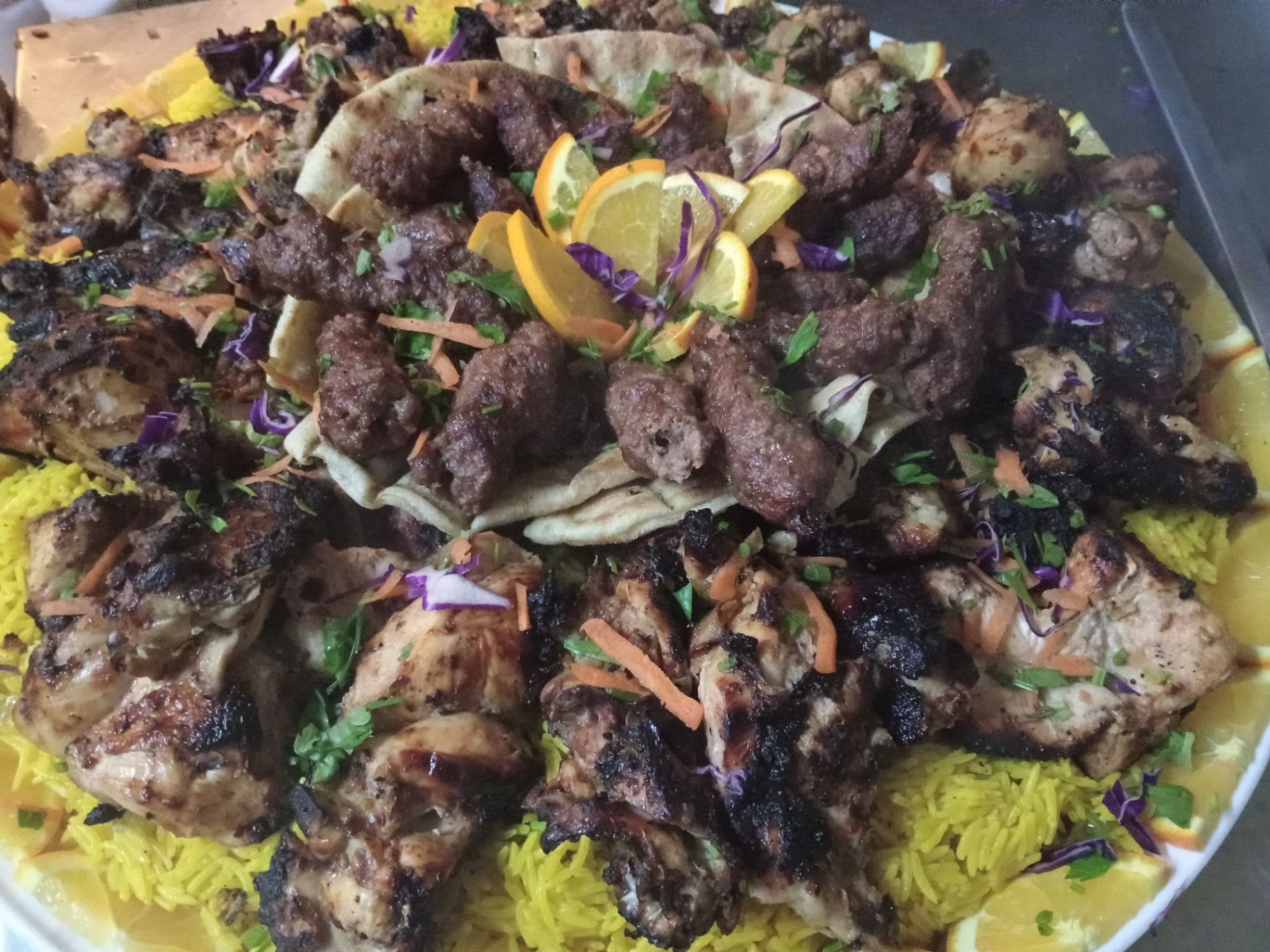 Meal that fits hand 1/2 chicken, 1/2 kofta, 1/4 tarb, rice, bread, green salad, tahini and pickles.