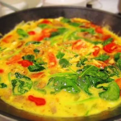 Omelet pan with vegetables, olives, and ghee