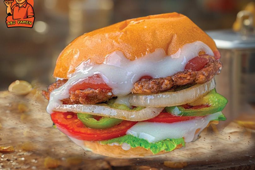 Plain grilled beef burger on charcoal