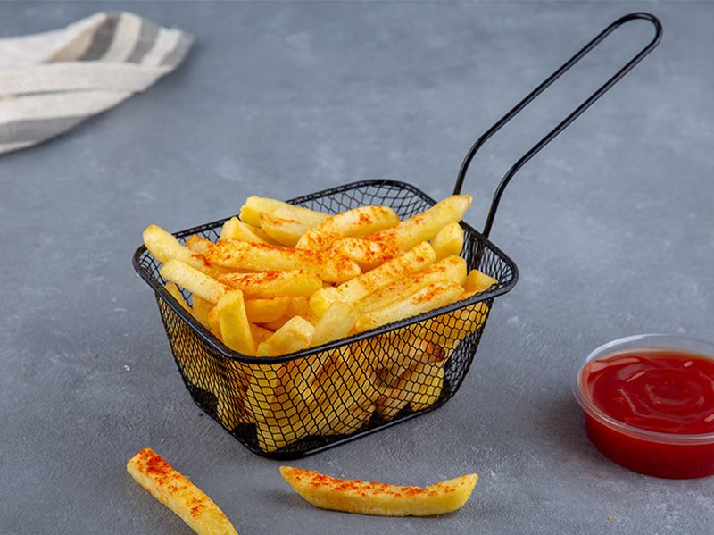 French Fries with Spices and Ketchup and Mayonnaise Packet