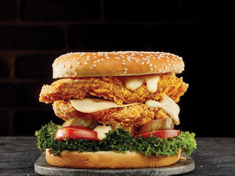 Turkey Chicken Sandwich - Two crispy chicken slices, a smoked turkey slice, cheese sauce, lettuce and mayonnaise