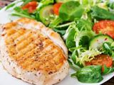 quarter chicken breast on grill with extra