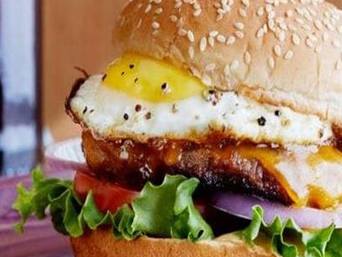Egg and cheese burger sandwich with fries and Pepsi
