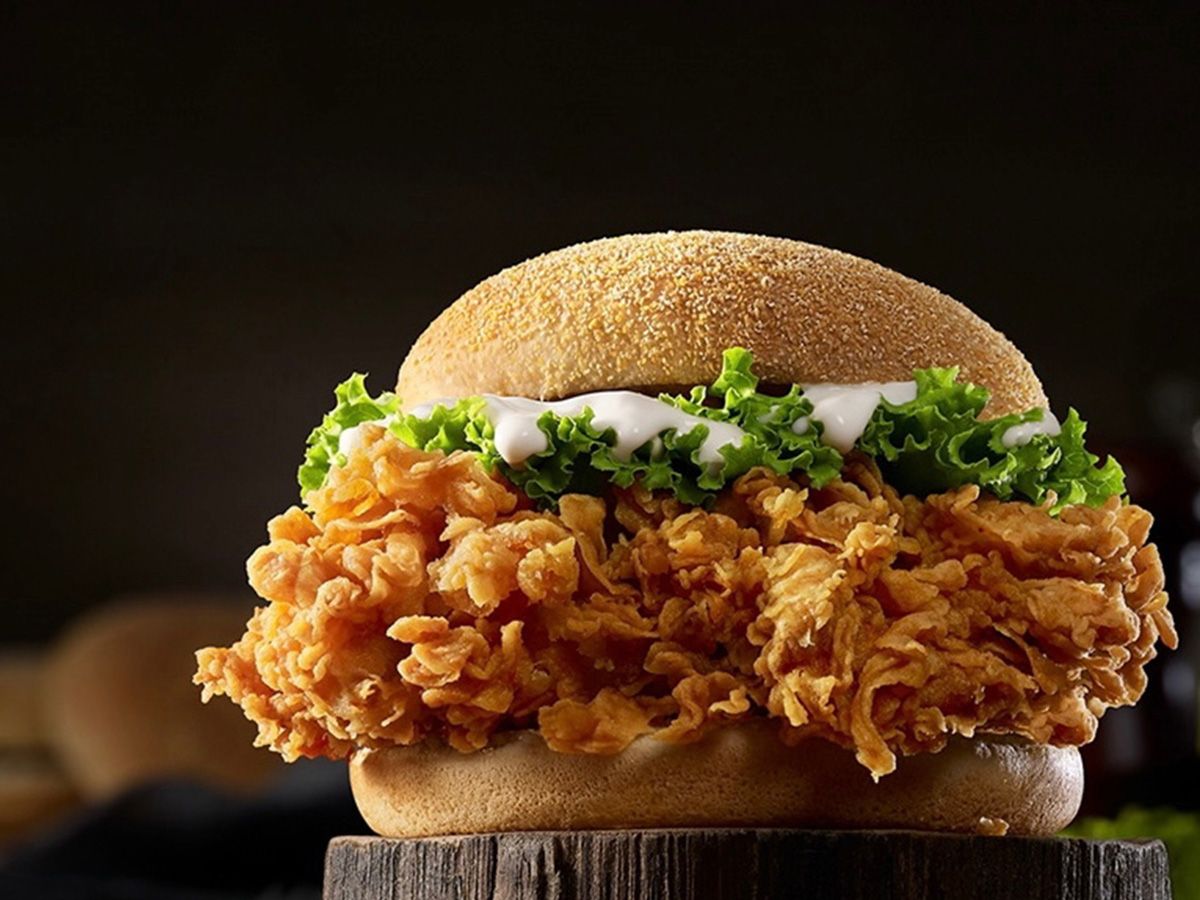 Fried chicken sandwich and sauces with potatoes